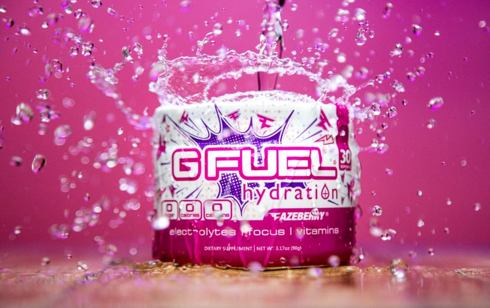 A FaZeberry G FUEL Hydration tub is being splashed by water.