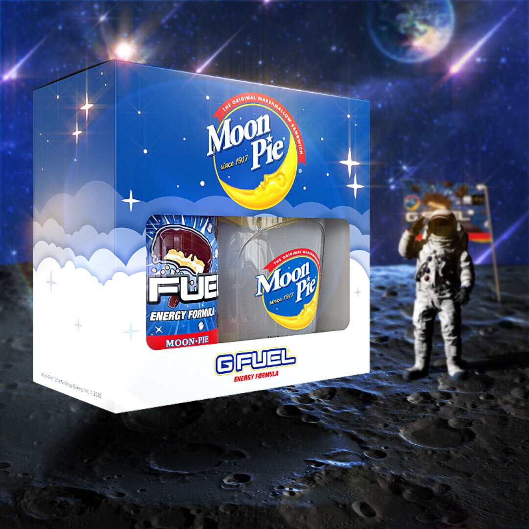 A G FUEL MoonPie collectors box, tub, and shaker cup is on the Moon next to an astronaut and Moon flag.