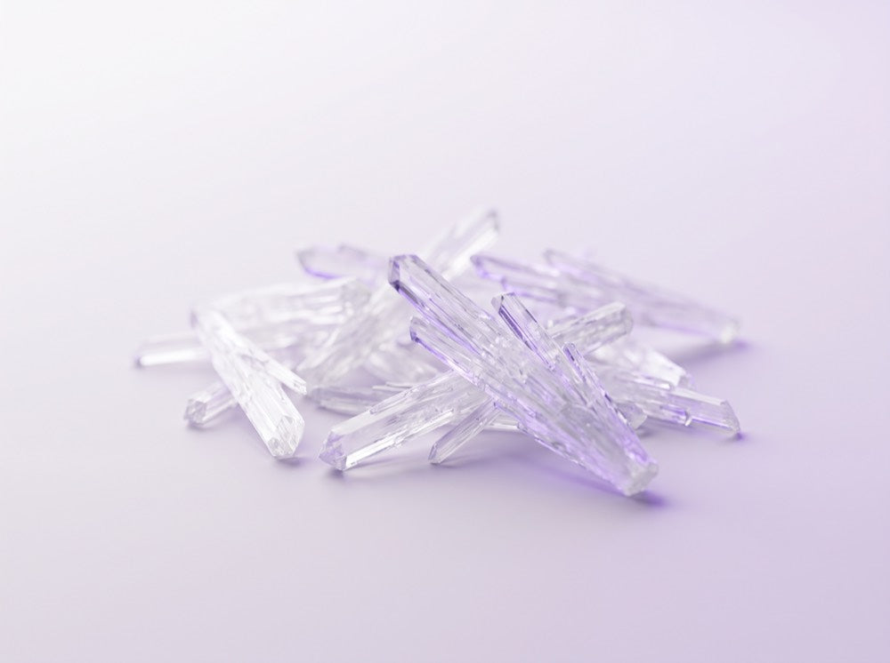 Amino acid crystals in a cluster on a lavender studio surface